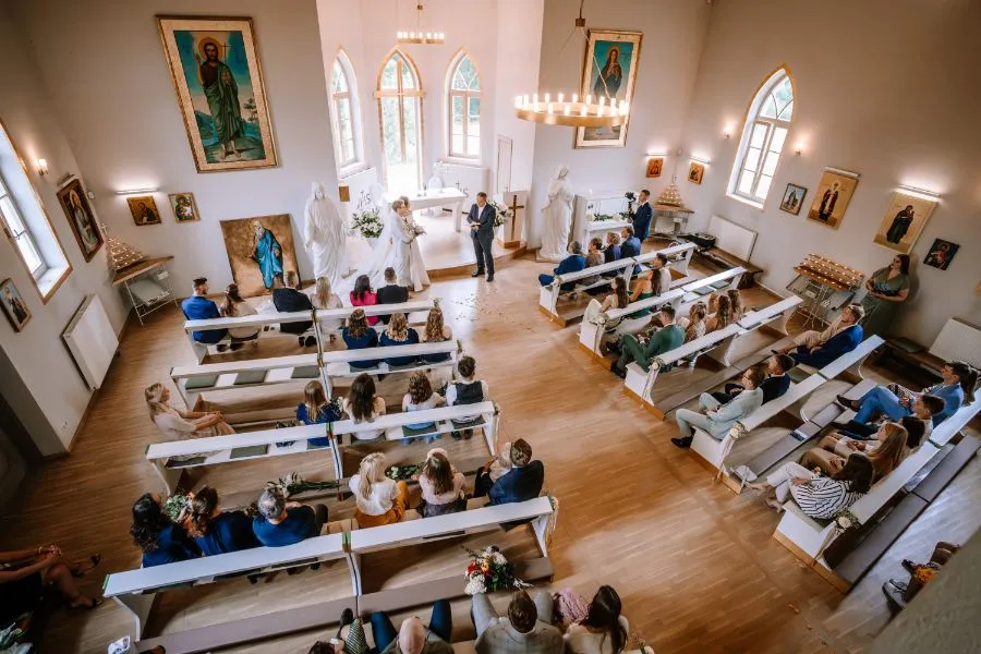 Candy bar de boda con macarons, vasitos de postre y dulces variados sobre mesa rústica decorada